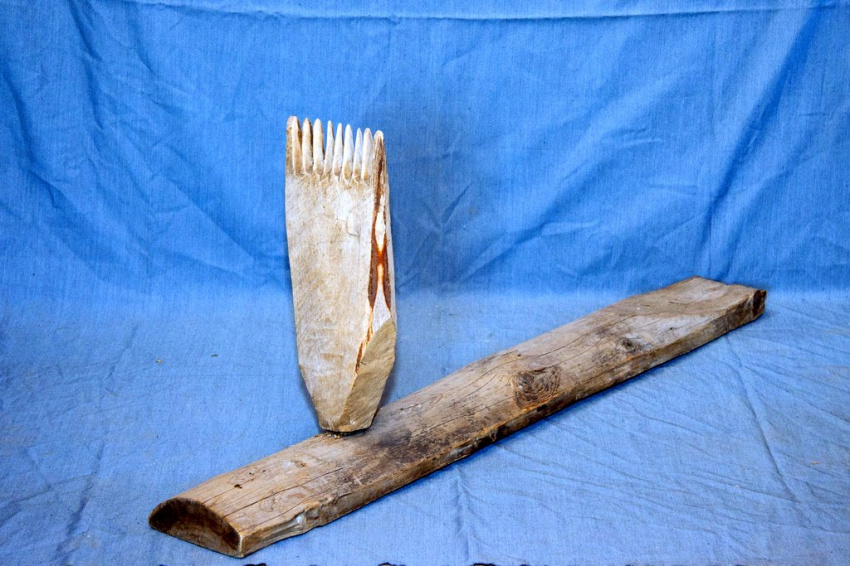 Инструмент представляет собой две соединëнных под прямым углом доски. Одна из них установлена на плоскую поверхность, она служит опорой и имеет закругление верхней части.  Вторая, установленная перпендикулярно, имеет ряд зубцов в верхней части и напоминае